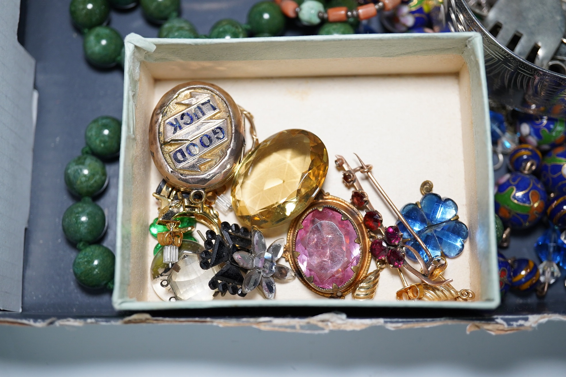 A quantity of assorted Victorian and later jewellery, including a 'Good Luck' oval locket, 9ct and garnet cluster brooch, a coral branch necklace, sterling bangle, part of a Chinese white metal buckle, Italian glass bead